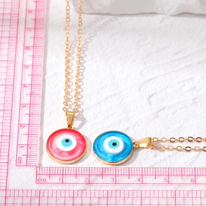 Blue and red Evil Eye necklaces with gold chains and scale measurement reference