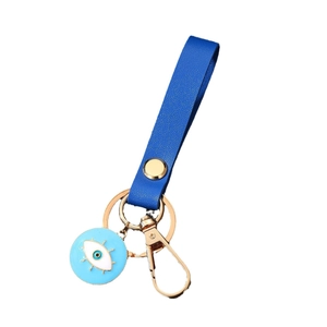 Minimalist evil eye keychain featuring navy blue leather strap and enamel heart pendant