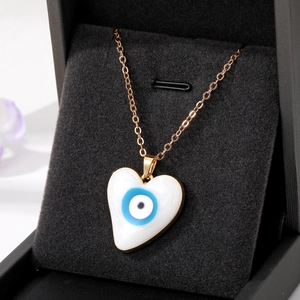 Elegant heart-shaped blue evil eye pendant necklace in golden finish on black jewelry box
