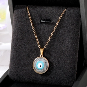 Gold Evil Eye necklace with marble texture pendant displayed in a premium jewelry box