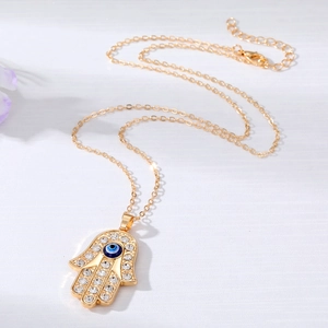 Bohemian Hamsa Hand pendant necklace with blue evil eye and sparkling rhinestones