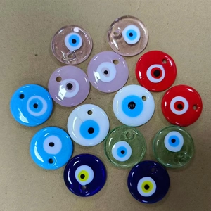 Macro detail of colorful flat round glass Evil Eye beads with pre-drilled holes for DIY