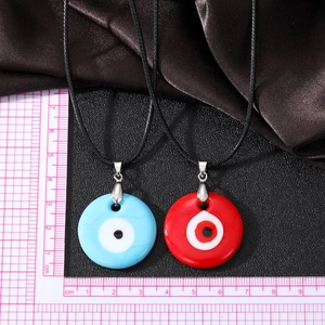 Vintage evil eye glass pendant necklace with woven cord available in blue and red