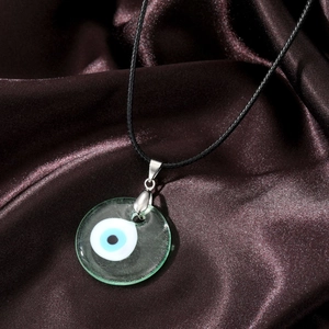 Detailed view of the Evil Eye glass pendant with silver clasp and black wax cord