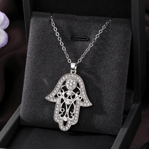 Detail of Hamsa Hand heart necklace featuring crystal rhinestones in a silver finish