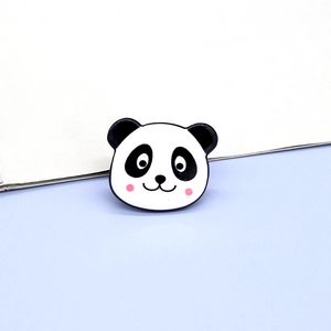 Close-up of a cute panda enamel brooch pin with black and white resin finish