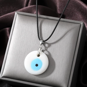 Vintage Turkish evil eye pendant necklace with blue glass on a luxury jewelry box