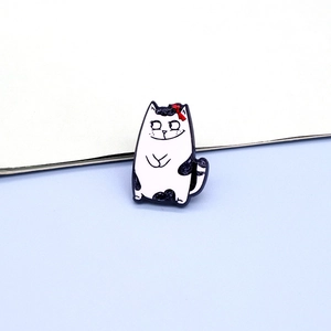 Cute cartoon cat resin acrylic brooch pin with black patches and a red bow for clothing