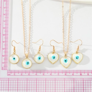 Minimalist evil eye jewelry set with round and heart blue stone pendants and gold chains