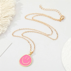 Chic golden alloy chain necklace with a pink drip oil smiley face pendant for women