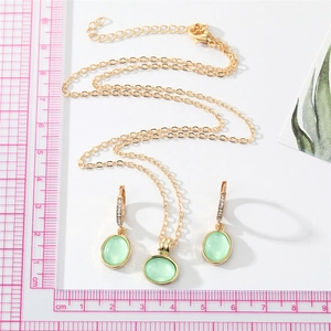 Vintage gold jewelry set with green oval opal pendant necklace and hoop earrings