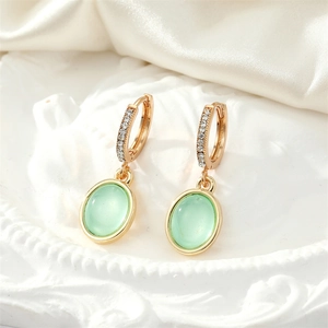 Vintage gold hoop earrings with green oval opal pendant and sparkling rhinestones
