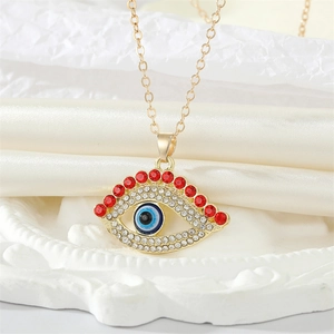 Vintage gold evil eye necklace with red crystal eyelashes and pavé cubic zirconia