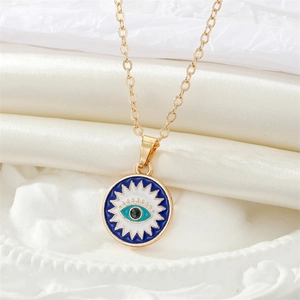 Vintage gold necklace with turquoise evil eye pendant on elegant silk background