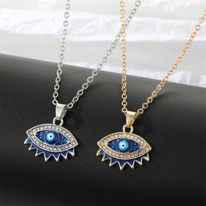 Vintage evil eye pendant necklaces in gold and silver with blue stones and crystals