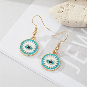 Bohemian gold evil eye earrings with blue enamel finish on white background