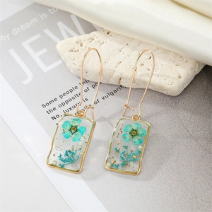 Handmade rectangular drop earrings with blue dried flowers, gold foil, and pearls