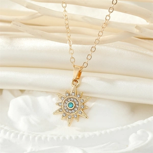 Elegant gold sun queen pendant necklace with blue gemstone and sparkling rhinestones