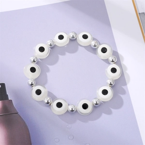 Vintage evil eye elastic bracelet with white resin beads and silver metallic spacers