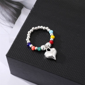 Colorful beaded elastic ring with silver round beads and a polished heart charm pendant