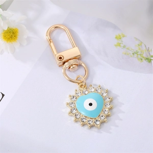 Detailed view of evil eye heart keychain with sparkling rhinestones and gold lobster clasp