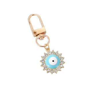 Golden evil eye keychain with sunburst design and sparkling white rhinestones