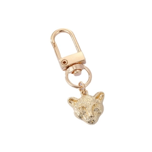 Golden alloy leopard head keychain with intricate engraved patterns and spring lobster clasp