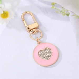Golden alloy heart keychain with pink enamel and sparkling rhinestone heart decoration