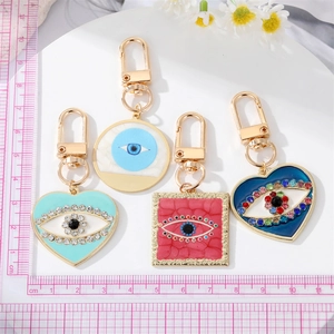 Close-up of bohemian evil eye charms with colorful enamel and inset rhinestones