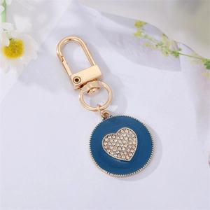 Detail view of heart-shaped rhinestone keychain with royal blue enamel finish