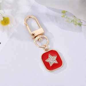 Star-patterned red drip oil pendant keychain with gold plating and sparkling crystals