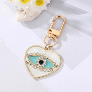 Detailed macro view of heart-shaped keychain with evil eye design and crystal inlay