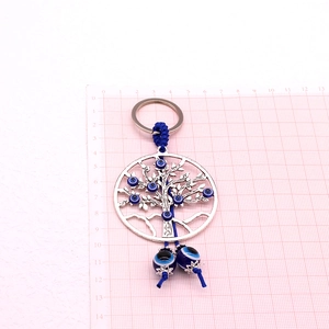 Détails du porte-clés Arbre de Vie en argent rétro avec charmes Evil Eye en résine bleue
