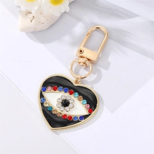 Macro shot of evil eye heart keychain with sparkling rhinestones and golden clip