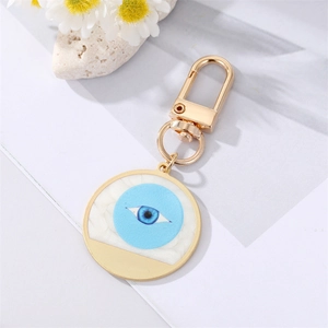 Golden Evil Eye keychain with marble pattern and blue rhinestone heart pendant