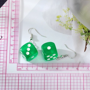 Trendy green resin dice earrings with white dots on silver ear hooks for women