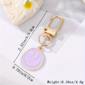 Detailed view of purple smiley face charm keychain with 5.9cm length measurements