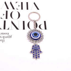 Vintage Hamsa hand and evil eye keychain with blue rhinestones and silver finish
