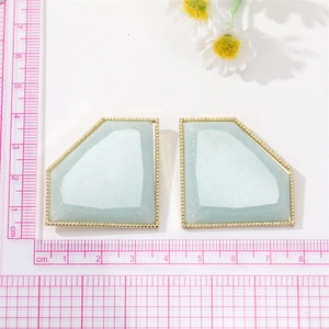 Exaggerated light blue resin glitter geometric earrings with gold beaded edges