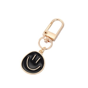 Golden alloy keychain with a black enamel smiley face pendant for bags and accessories
