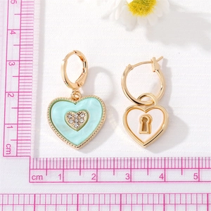 Vintage gold heart earrings with mint green and white enamel and rhinestone inlay