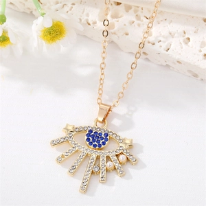 Dettaglio della collana occhio del male dorata con strass blu e piccole perle