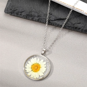 Handmade clear resin pendant necklace featuring a real white daisy flower and silver chain
