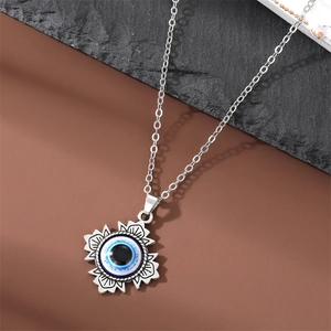 Detailed macro view of retro silver Evil Eye pendant with bohemian sunburst metal frame