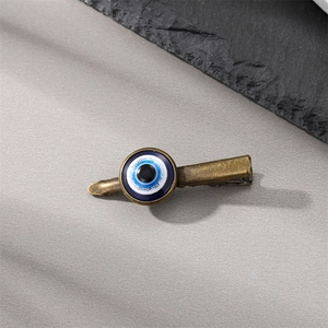 Vintage bronze evil eye hair clip featuring a classic blue Turkish eye glass bead charm