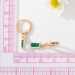 Detailed view of green crystal earrings with gold plating and size measurements