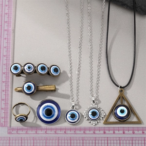 Detailed set of evil eye jewelry and hair accessories with blue enamel and scale ruler