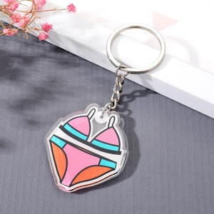 Cute cartoon bikini acrylic keychain with silver ring on a minimalist background