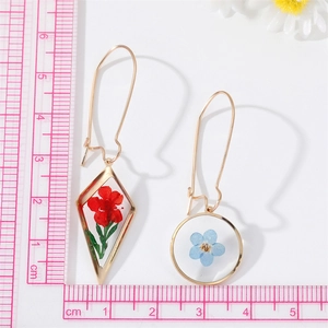 Detail view of handmade dried flower earrings with a ruler showing the 6cm total length