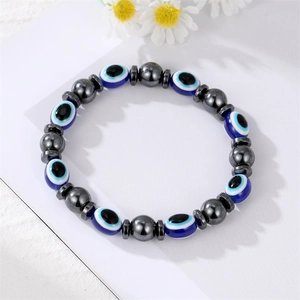 Detailed macro of Evil Eye blue beads and metallic spacers on an elastic bracelet